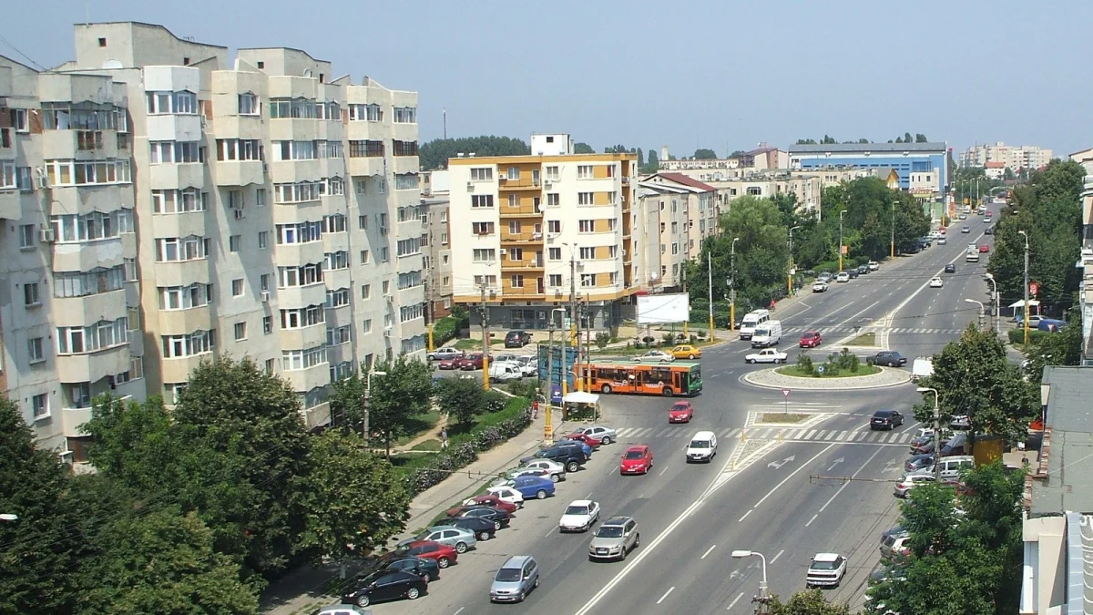 Bulevard în cartierul Inel II din Constanța, cu blocuri de locuințe, un sens giratoriu și mașini parcate de-a lungul trotuarului (fotografie de arhivă)